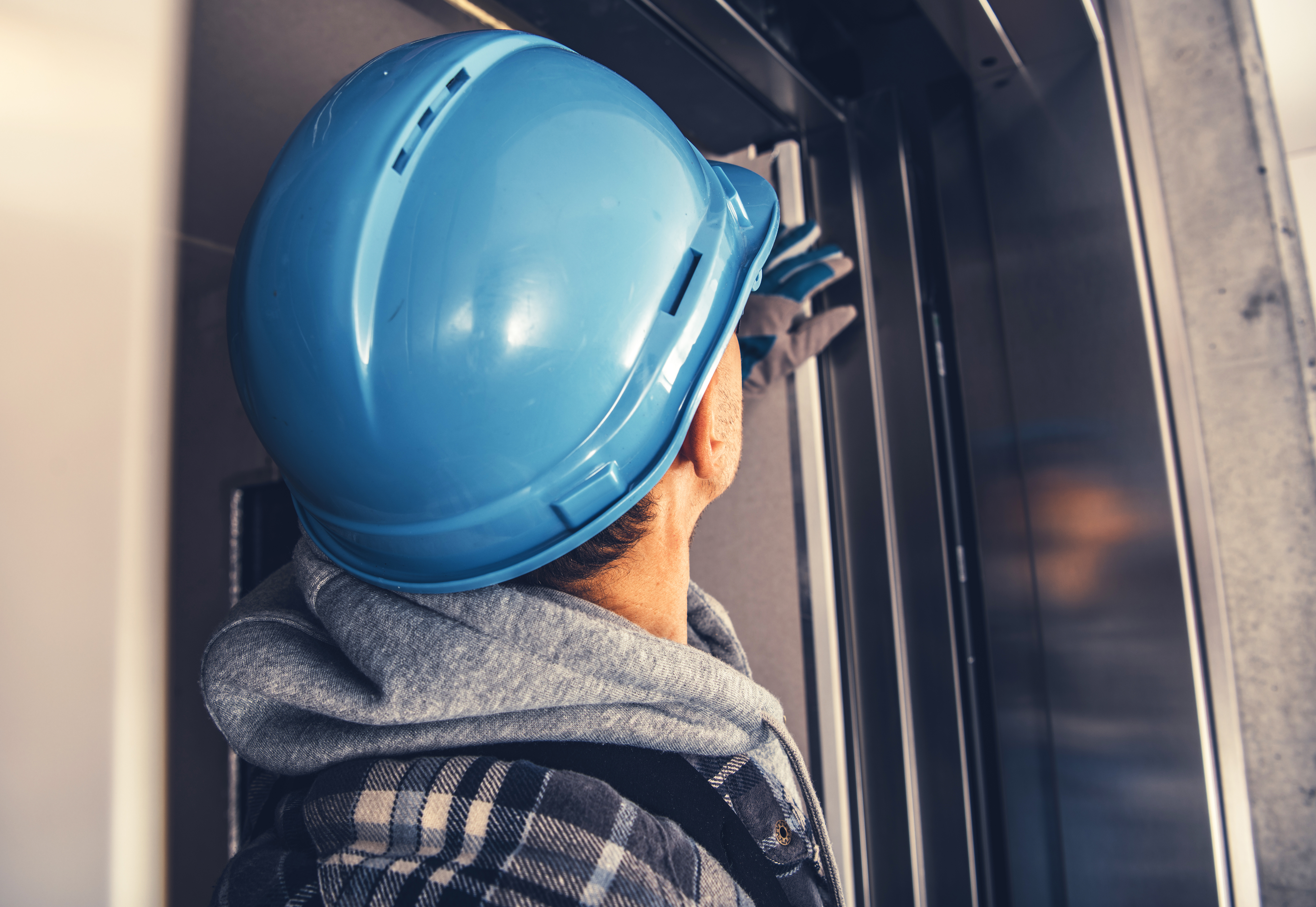 a man installing an automatic door closer